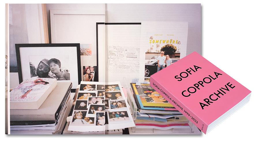 Pink Sofia Coppola Book in front of a stack of books and papers